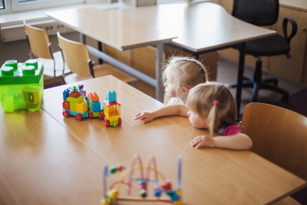 little-girls-sitting-table-with-toys.jpg